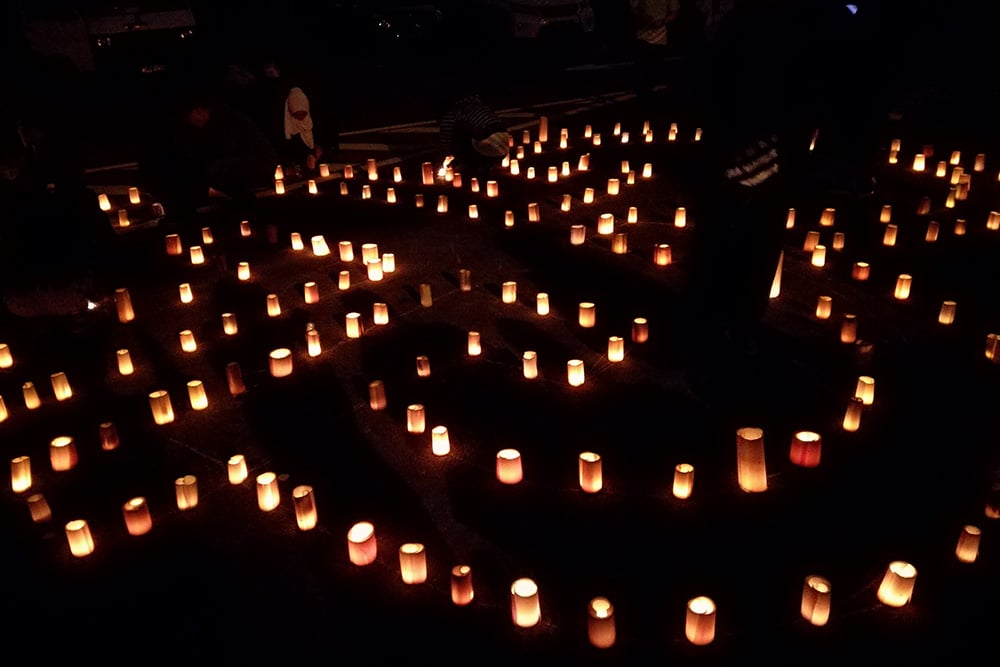 A display of the G3 monogram was created by G3 volunteers using 400 tealight candles, with lampshades made of banana trunks.